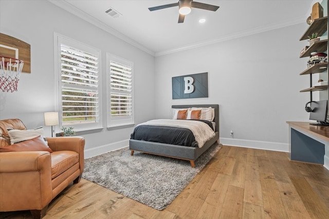 bedroom featuring hardwood / wood-style floors, ceiling fan, and crown molding