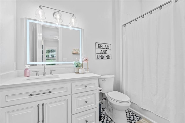 full bathroom with tile patterned flooring, vanity, toilet, and shower / bath combo with shower curtain