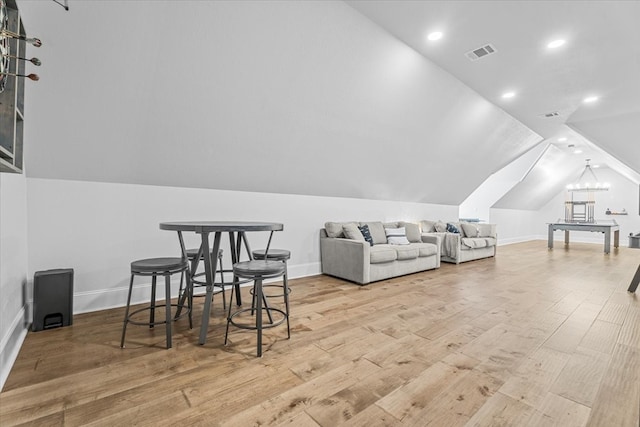 interior space with vaulted ceiling and light hardwood / wood-style flooring