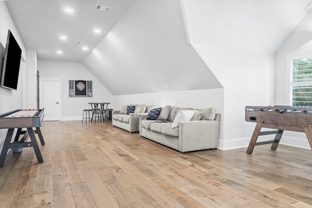 living room featuring light wood-type flooring and lofted ceiling