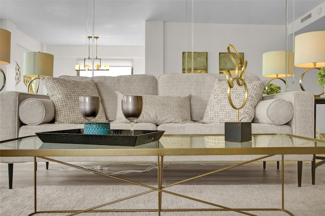 living room featuring wood-type flooring and a chandelier