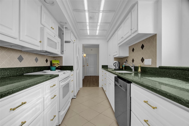 kitchen featuring backsplash, white cabinetry, sink, and white appliances