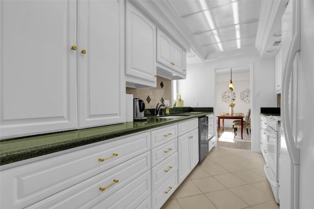 kitchen featuring white cabinetry, sink, white appliances, decorative backsplash, and light tile patterned flooring