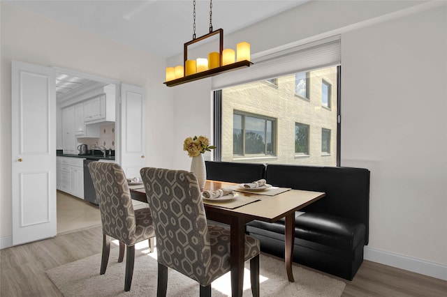 dining space with light hardwood / wood-style floors