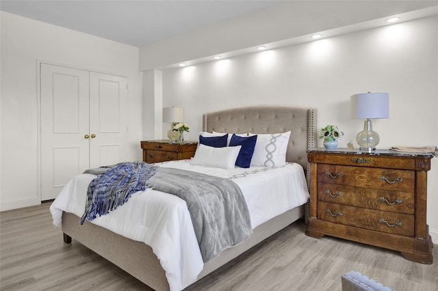 bedroom featuring light wood-type flooring and a closet