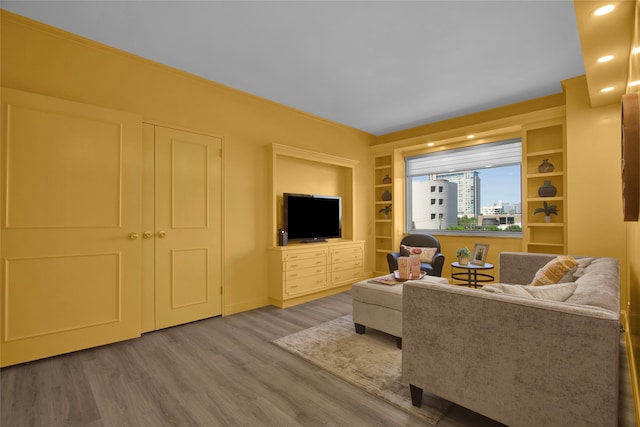 living room with hardwood / wood-style flooring and built in features