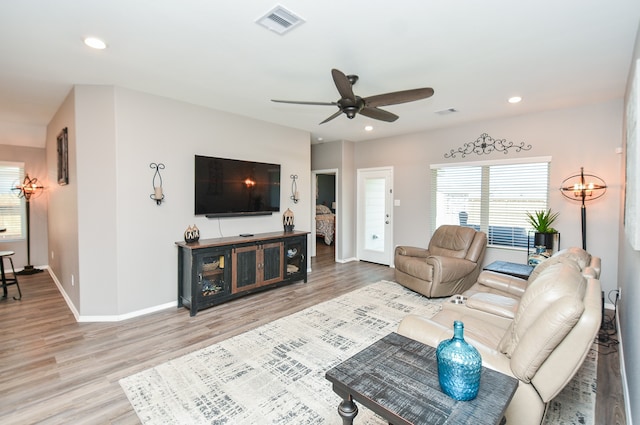 living room featuring hardwood / wood-style floors and ceiling fan