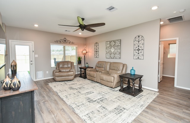 living room featuring hardwood / wood-style flooring and ceiling fan