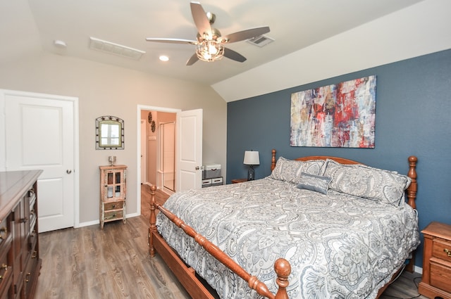 bedroom with hardwood / wood-style floors, ceiling fan, and vaulted ceiling