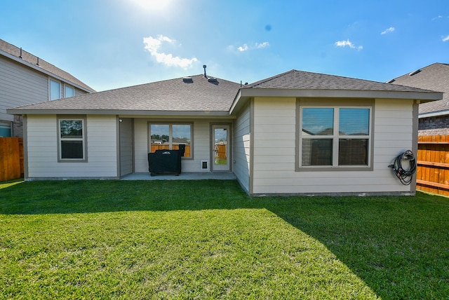 rear view of property with a patio area and a yard