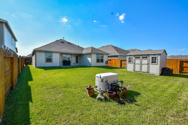 rear view of house with a shed and a yard