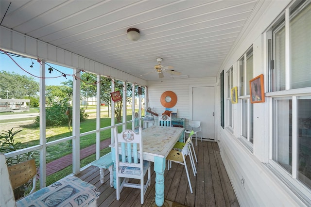 sunroom / solarium featuring ceiling fan