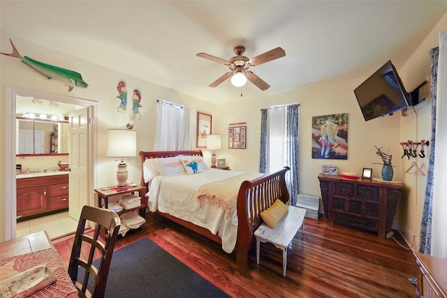 bedroom featuring connected bathroom, ceiling fan, and dark wood-type flooring