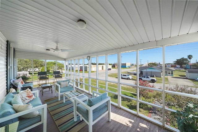 sunroom with ceiling fan and lofted ceiling