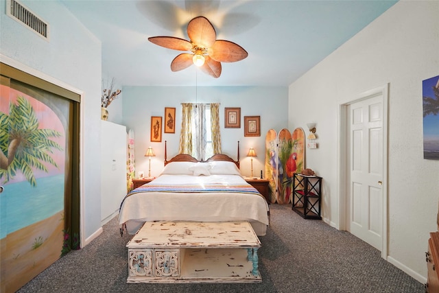 bedroom with ceiling fan and dark colored carpet