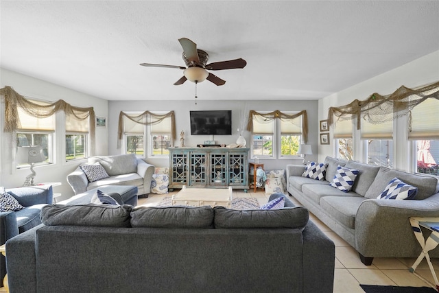 living room featuring ceiling fan, light tile patterned floors, and a wealth of natural light