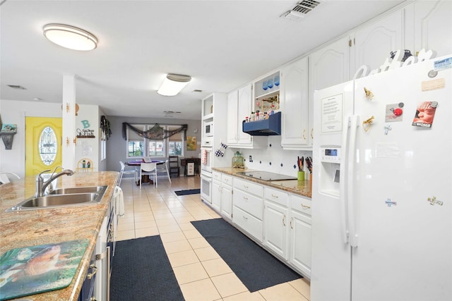 kitchen featuring white cabinets, light tile patterned floors, white appliances, and sink