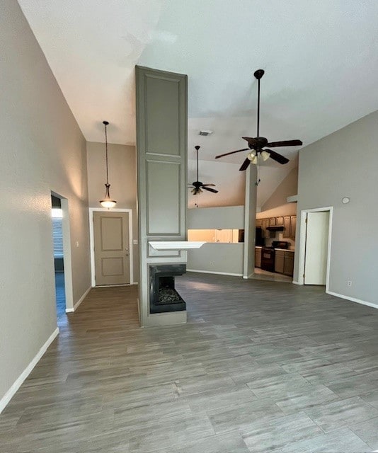 unfurnished living room with hardwood / wood-style flooring and high vaulted ceiling