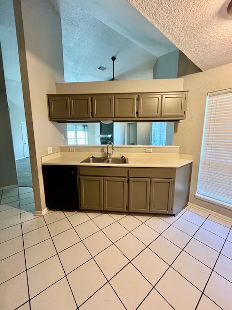 kitchen featuring sink, light tile patterned floors, a textured ceiling, and black dishwasher