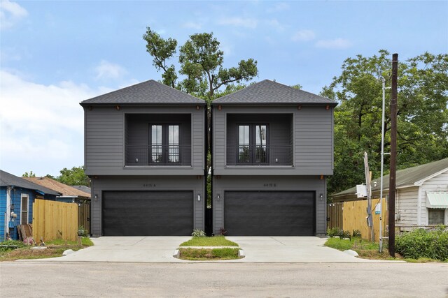 view of front facade featuring a balcony and a garage