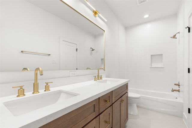 full bathroom featuring tile patterned floors, vanity, tiled shower / bath, and toilet