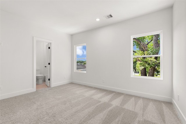 empty room featuring light colored carpet