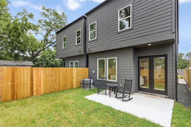 rear view of house with a yard and a patio