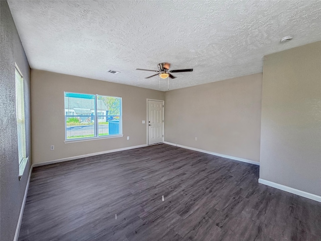 304 E Caroline St, Trinity, TX 75862 - unfurnished room featuring ceiling fan, dark hardwood / wood-style flooring, and a textured ceiling
