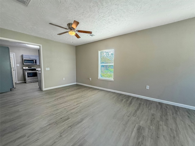 unfurnished room with hardwood / wood-style flooring, ceiling fan, and a textured ceiling