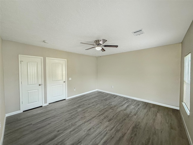 304 E Caroline St, Trinity, TX 75862 - unfurnished room with a textured ceiling, dark hardwood / wood-style flooring, and ceiling fan