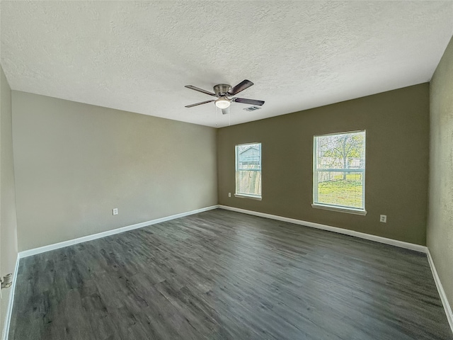 empty room featuring ceiling fan, dark hardwood / wood-style flooring, and a textured ceiling