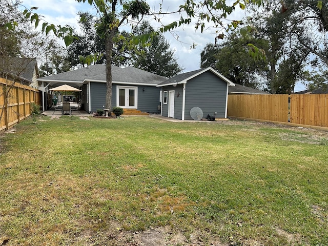 back of property featuring french doors, a patio area, and a lawn