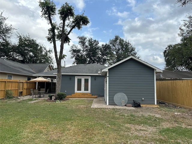 rear view of property with a lawn, french doors, and a patio