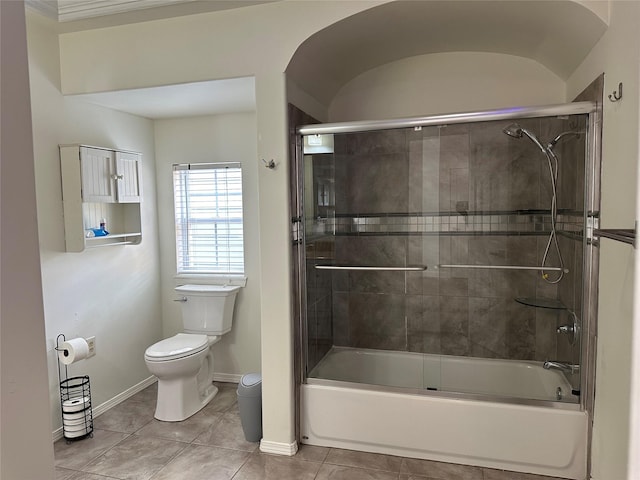 6811 Roswell St, Houston, TX 77022 - bathroom with toilet, tile patterned flooring, baseboards, and bath / shower combo with glass door