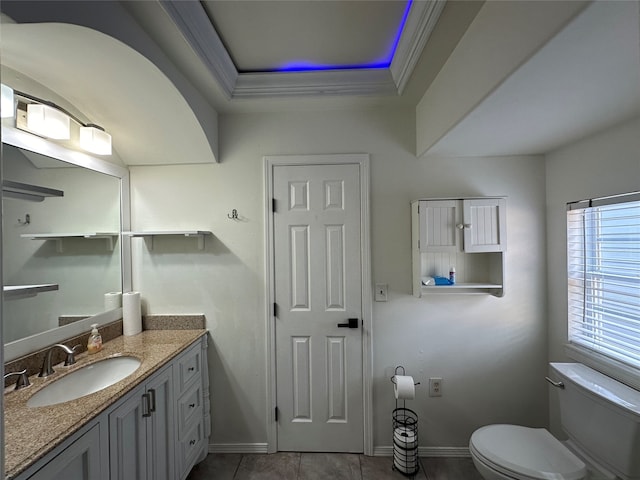 bathroom with tile patterned floors, vanity, a raised ceiling, crown molding, and toilet