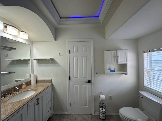 6811 Roswell St, Houston, TX 77022 - bathroom featuring a tray ceiling, toilet, vanity, baseboards, and tile patterned floors
