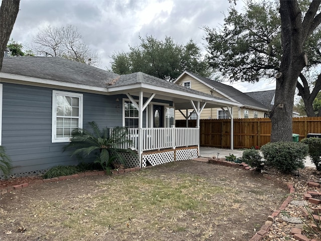 rear view of property featuring a porch