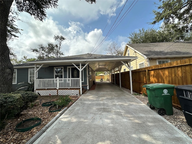 6811 Roswell St, Houston, TX 77022 - view of front of property with driveway, a porch, and an attached carport