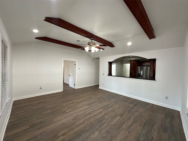 unfurnished living room with vaulted ceiling with beams, ceiling fan, and dark hardwood / wood-style floors