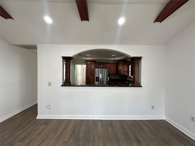 6811 Roswell St, Houston, TX 77022 - unfurnished living room featuring dark wood-type flooring, arched walkways, baseboards, beam ceiling, and recessed lighting