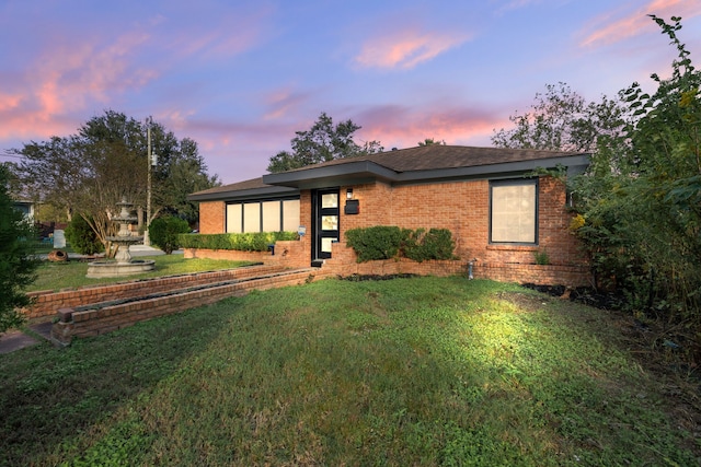 view of front of house with a yard