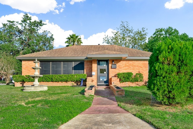 ranch-style home with a front lawn