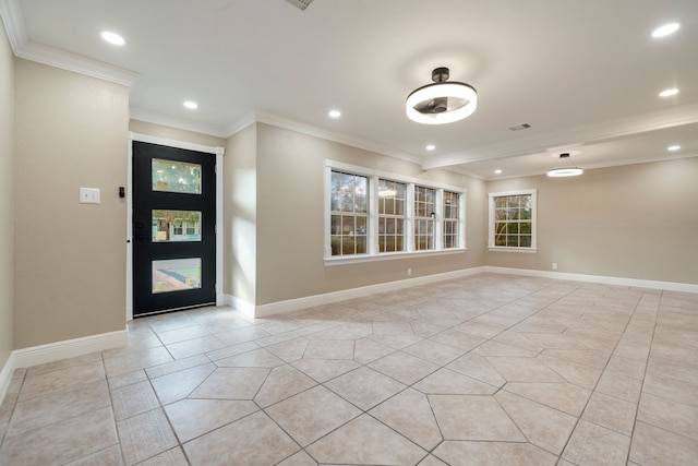 tiled entryway featuring crown molding