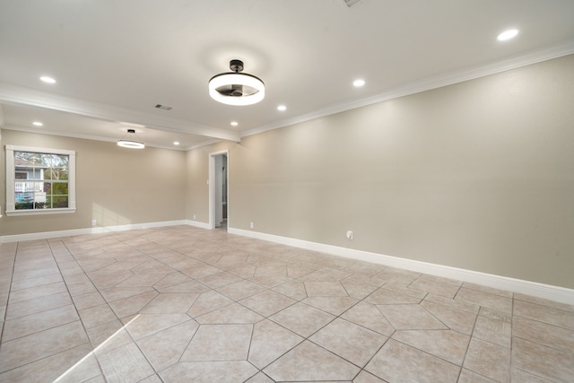 spare room featuring light tile patterned floors and crown molding