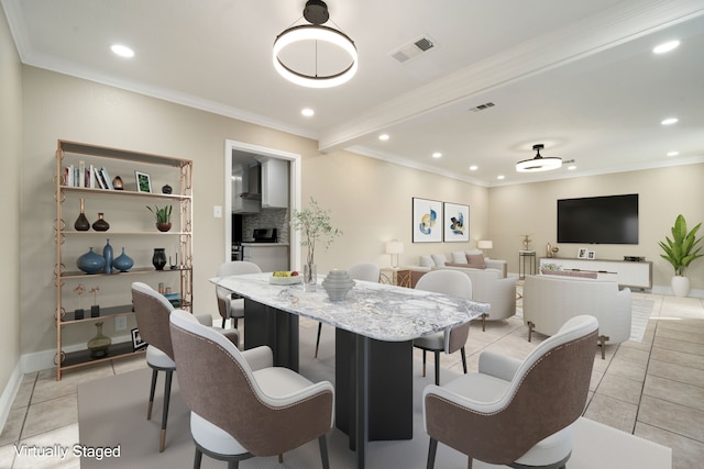 dining room with light tile patterned floors and ornamental molding