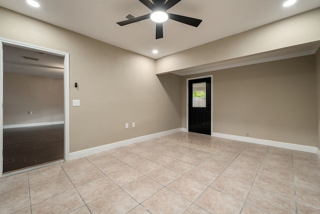 empty room featuring light tile patterned floors and ceiling fan