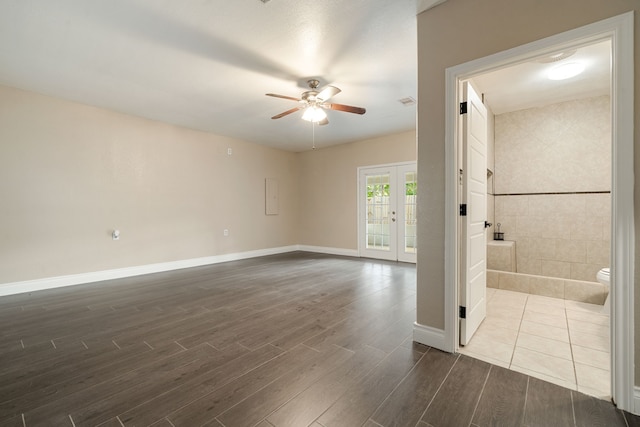 unfurnished room with ceiling fan, french doors, and dark hardwood / wood-style floors