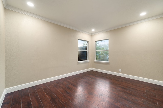 spare room featuring crown molding and dark wood-type flooring