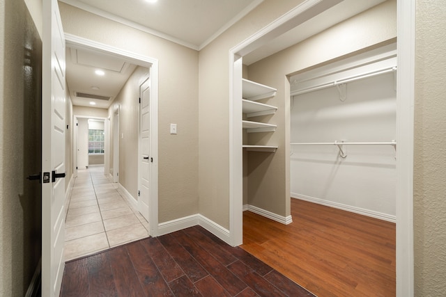 hallway featuring hardwood / wood-style floors and crown molding