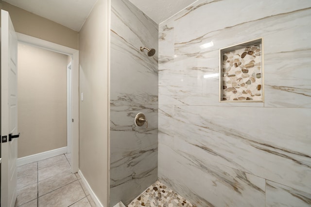 bathroom featuring tile patterned floors and a tile shower